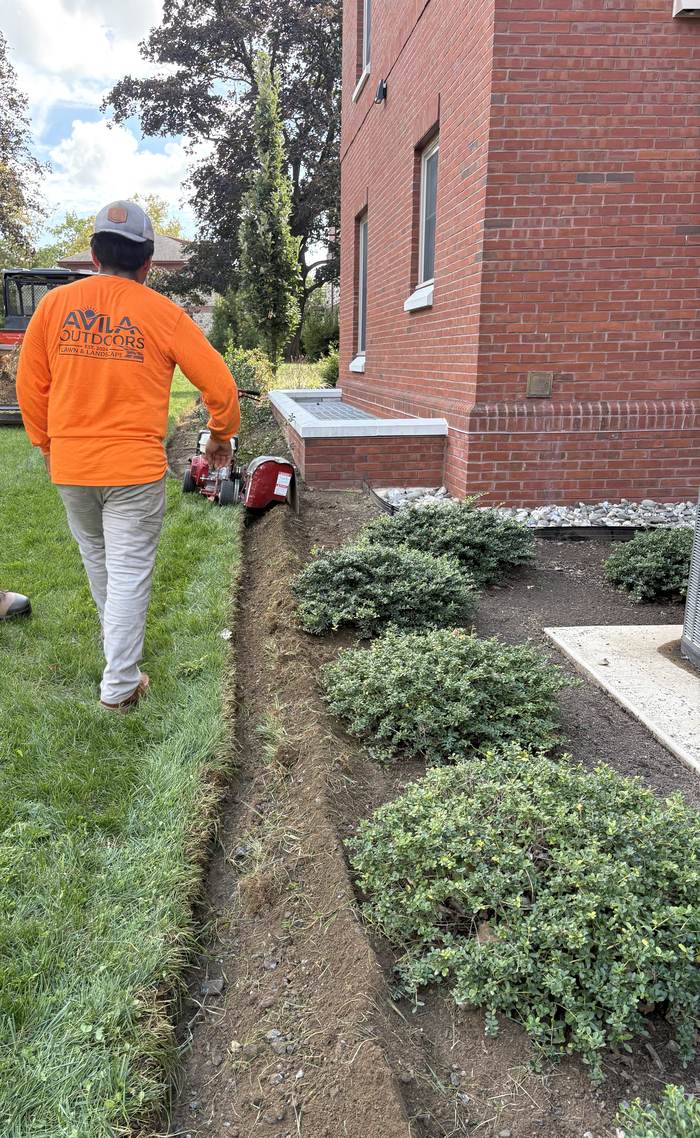 Avila Outdoors crew trenching a garden bed edge