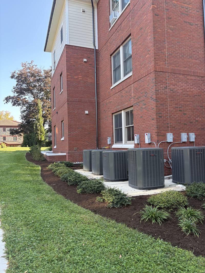 Mulch bed installation along a building foundation